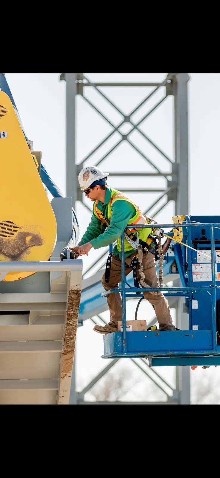 Caleb working on site from aerial lift