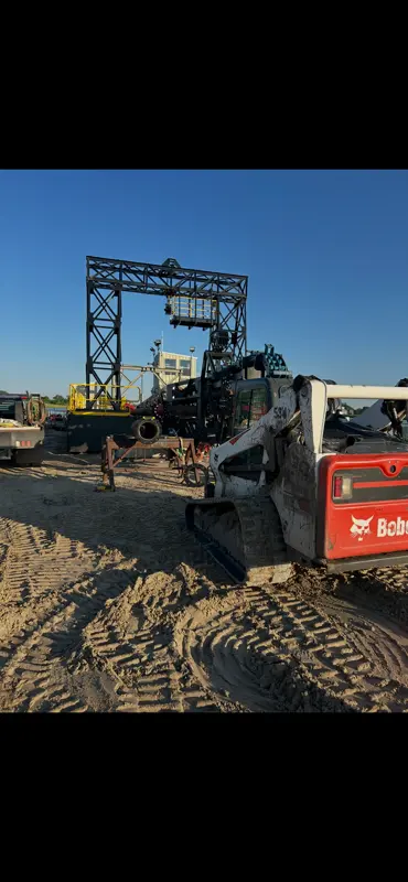 Bobcat skid steer and heavy equipment at construction site