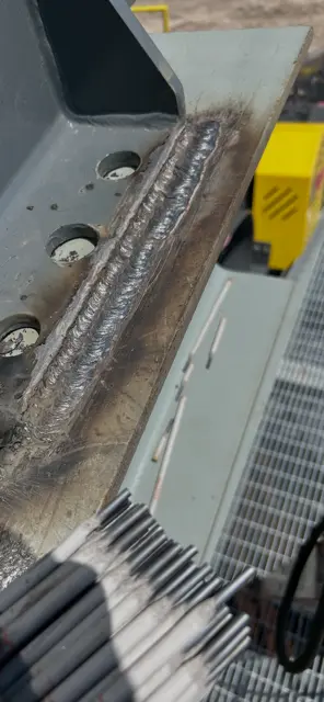 Close-up of completed weld bead on steel plate
